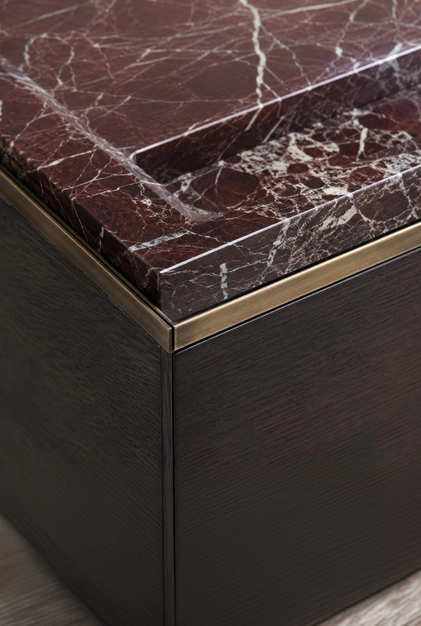 X4 Design and Build burgundy marble countertop detail with dark wood cabinet, brass shadow line, sharp stone edge, and luxury interior finishing